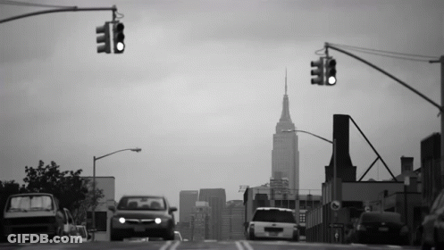 Black And White City Street With Tall Building GIF