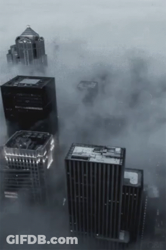A Black And White Photo Of A City With A Lot Of Buildings GIF