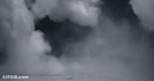 A Black And White Photo Of A Cloudy Sky With A Boat In The Distance . GIF