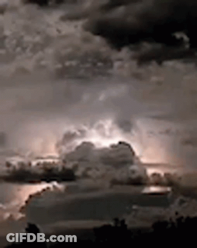 A Black And White Photo Of A Cloudy Sky With Lightning GIF
