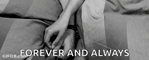 A Black And White Photo Of A Couple Holding Hands . GIF