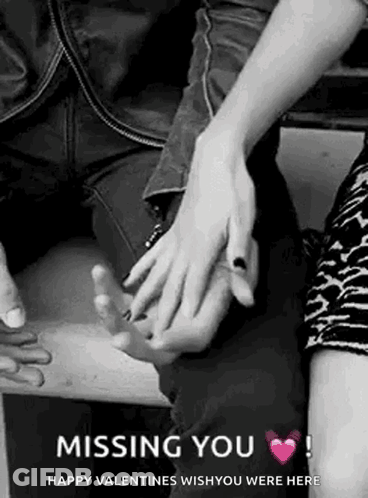 A Black And White Photo Of A Couple Holding Hands . GIF