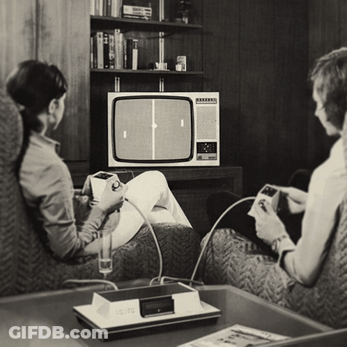 A Black And White Photo Of A Couple Playing A Game On A Commodore GIF