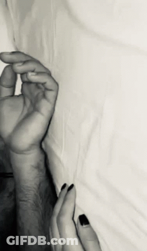 A Black And White Photo Of A Couple 'S Hands GIF