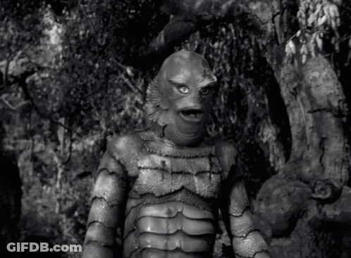 A Black And White Photo Of A Creature From The Black Lagoon Standing In The Woods . GIF