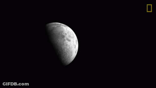 A Black And White Photo Of A Crescent Moon In The Night Sky GIF
