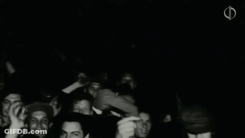 A Black And White Photo Of A Crowd Of People With The Letter F In The Upper Right Corner GIF