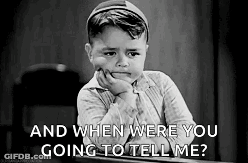 A Black And White Photo Of A Crying Boy Sitting At A Desk . GIF
