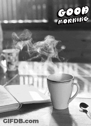 A Black And White Photo Of A Cup Of Coffee With Smoke Coming Out Of It GIF
