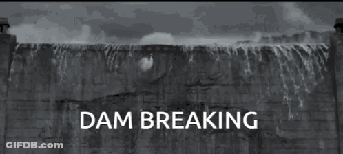 A Black And White Photo Of A Dam With The Words " Dam Breaking " Below It GIF