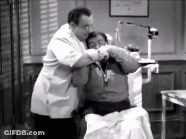 A Black And White Photo Of A Dentist Examining A Patient . GIF