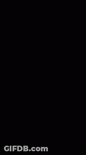 A Black And White Photo Of A Diamond Ring With A Pink Flower In The Middle GIF
