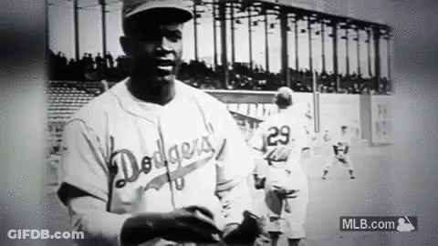 A Black And White Photo Of A Dodgers Baseball Player Holding A Baseball Glove . GIF