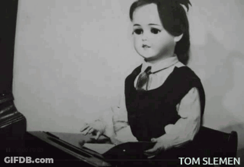 A Black And White Photo Of A Doll With The Name Tom Slemen Underneath It GIF
