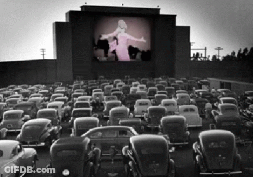 A Black And White Photo Of A Drive-In Theater GIF
