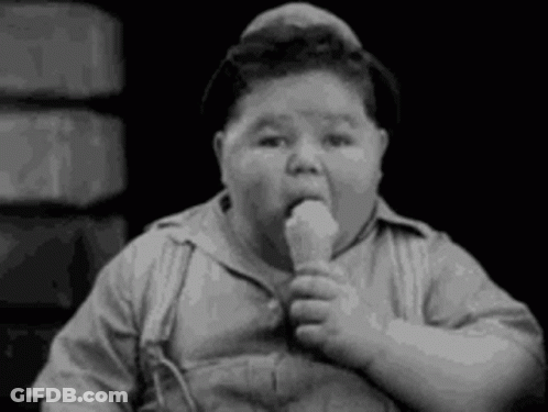 A Black And White Photo Of A Fat Boy Eating A Ice Cream Cone . GIF