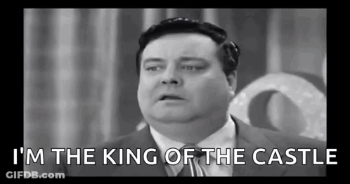 A Black And White Photo Of A Fat Man In A Suit And Tie Talking . GIF