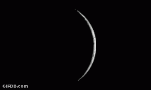 A Black And White Photo Of A Full Moon On A Black Background GIF