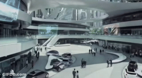 A Black And White Photo Of A Futuristic Building With Cars Parked GIF