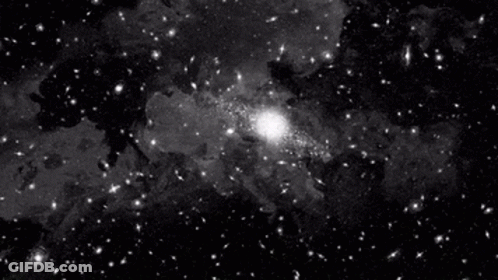 A Black And White Photo Of A Galaxy With A Lot Of Stars GIF