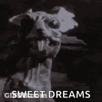A Black And White Photo Of A Gargoyle With The Words `` Sweet Dreams '' Written Next To It . GIF