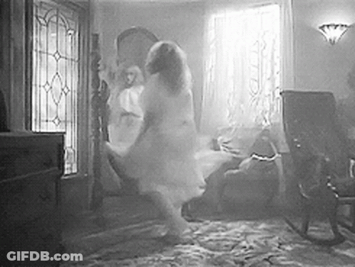 A Black And White Photo Of A Ghost Dancing In A Living Room . GIF