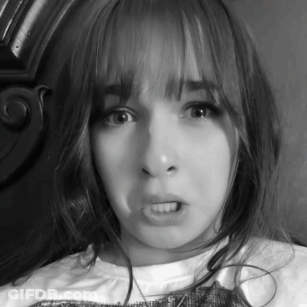 A Black And White Photo Of A Girl Making A Face GIF