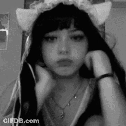 A Black And White Photo Of A Girl Wearing A Cat Ear Headband . GIF