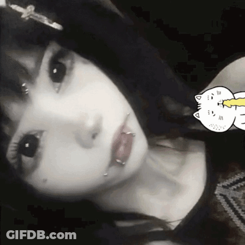 A Black And White Photo Of A Girl With Piercings In Her Lips GIF