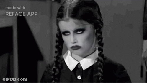 A Black And White Photo Of A Girl With Pigtails And A Serious Look On Her Face . GIF