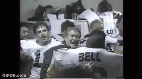 A Black And White Photo Of A Group Of Football Players One Of Whom Has The Name Bell On His Jersey GIF