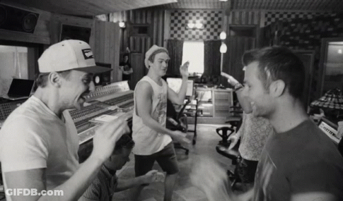 A Black And White Photo Of A Group Of Men In A Recording Studio With One Wearing A Hat That Says Budweiser GIF
