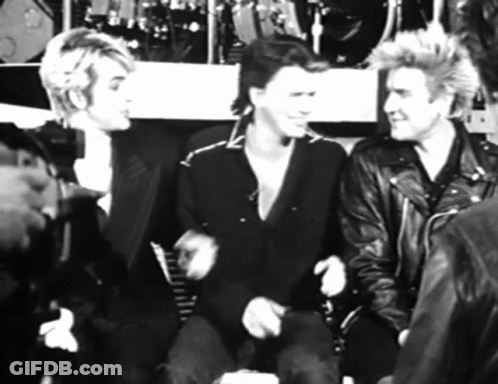 A Black And White Photo Of A Group Of Men In Leather Jackets GIF