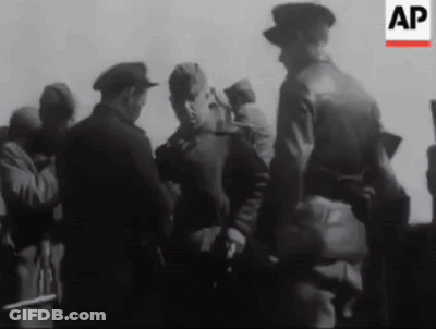 A Black And White Photo Of A Group Of Men Standing Next To Each Other With The Letters Ap In The Corner . GIF