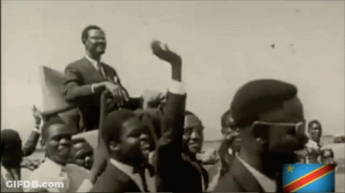A Black And White Photo Of A Group Of Men With A Flag In The Corner GIF