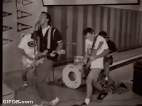 A Black And White Photo Of A Group Of People Playing Instruments . GIF
