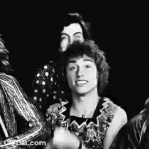 A Black And White Photo Of A Group Of People Standing Next To Each Other And Smiling . GIF