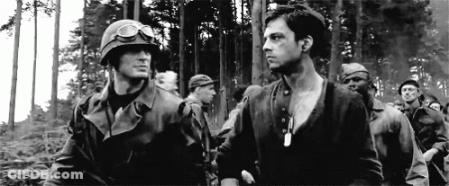 A Black And White Photo Of A Group Of Soldiers In A Forest . GIF