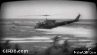 A Black And White Photo Of A Helicopter Flying Over A Body Of Water With Makeagif.com At The Bottom GIF