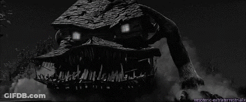A Black And White Photo Of A House With A Monster Face On It GIF