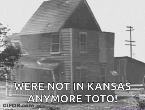 A Black And White Photo Of A House With The Words " We 'Re Not In Kansas Anymore Toto " GIF