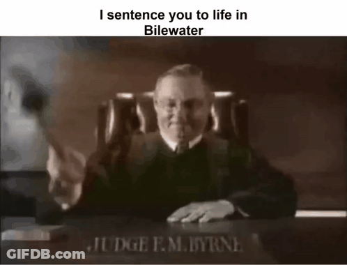 A Black And White Photo Of A Judge Sitting At A Desk With A Gavel In Front Of Him . GIF