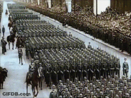 A Black And White Photo Of A Large Military Parade GIF