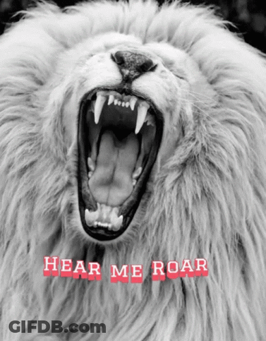 A Black And White Photo Of A Lion With Its Mouth Open And The Words Hear Me Roar Below It GIF