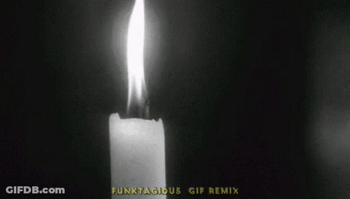A Black And White Photo Of A Lit Candle With The Words Lights Out GIF