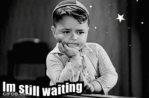 A Black And White Photo Of A Little Boy With The Words I 'M Still Waiting On The Bottom GIF