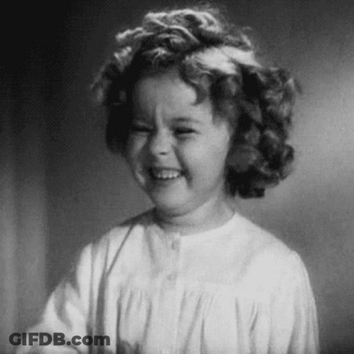 A Black And White Photo Of A Little Girl Laughing . GIF