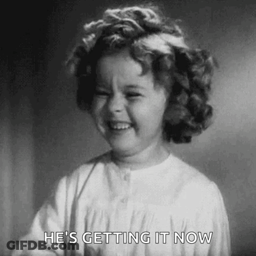 A Black And White Photo Of A Little Girl Laughing . GIF