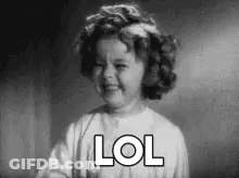 A Black And White Photo Of A Little Girl Laughing With The Word Lol Written On Her Face . GIF