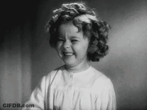 A Black And White Photo Of A Little Girl Laughing . GIF